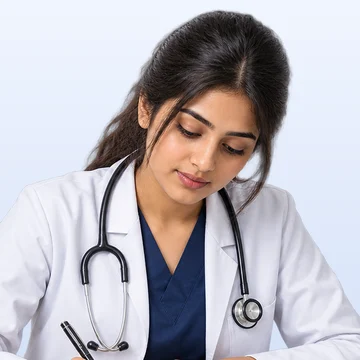 A medical student writing notes at her desk