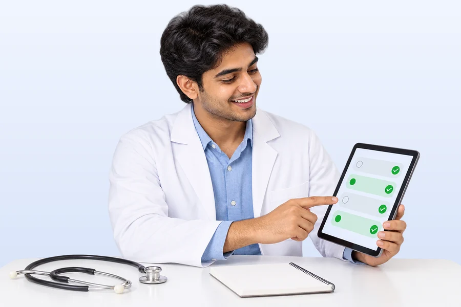 A medical student smiling at a quiz with ticked answers on his tablet